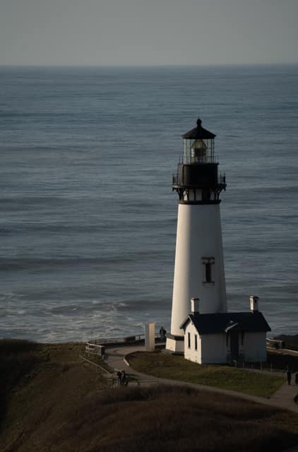 White lighthouse against a flat sea