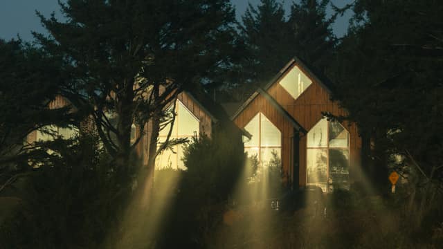 A-frame cabins in fog with light rays