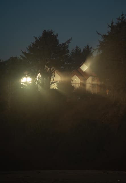 Cabin lights burning through fog