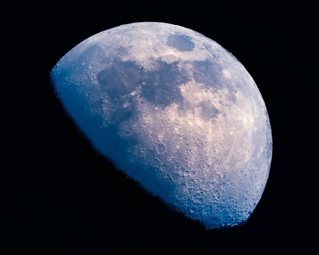 Waxing moon in crisp detail against deep blue