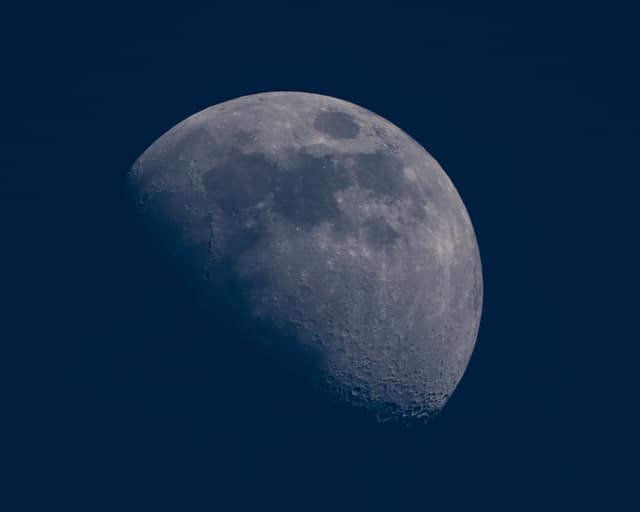 Daytime moon in deep blue