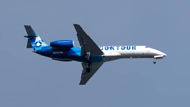 Passenger jet climbing across blue