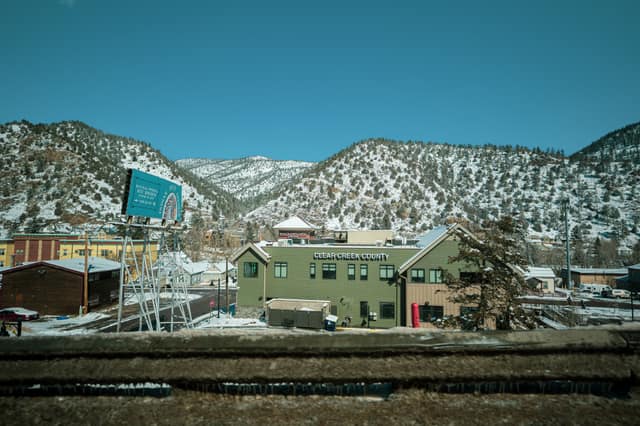 Snow-dusted town below winter hills