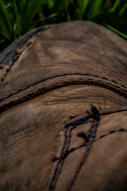 Worn boot leather and stitching, macro
