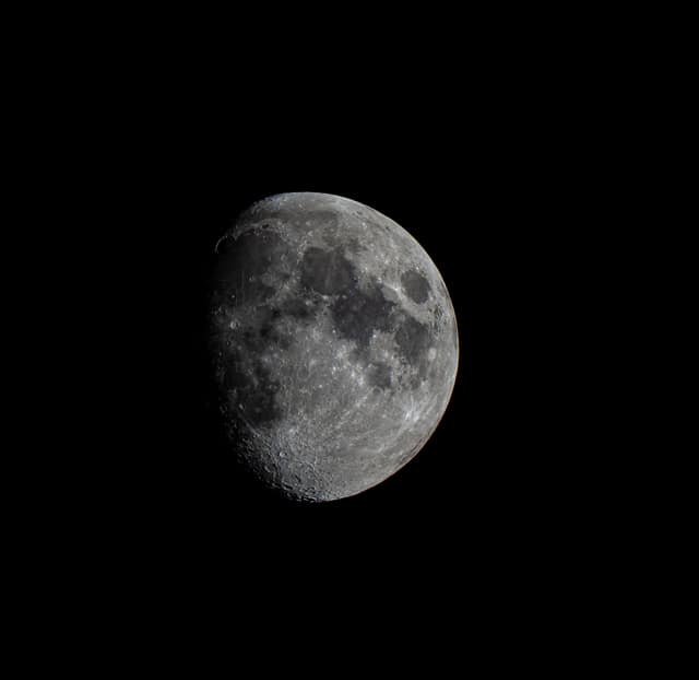 Gibbous moon against black