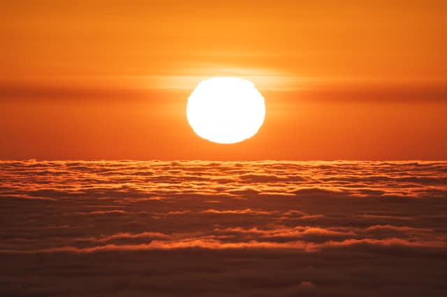 Sun breaking over an ocean of clouds
