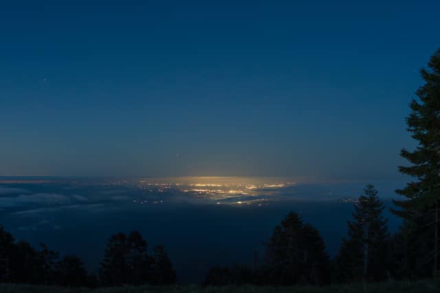 Distant town lights under fading sky