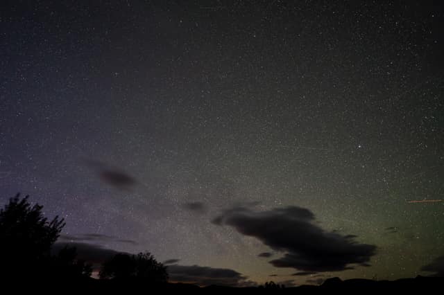 Stars through drifting night clouds