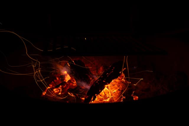 Campfire embers glowing at night