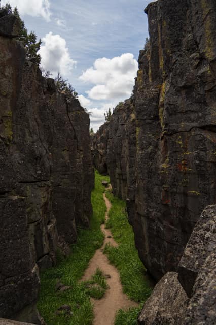 Narrow slot canyon with a walking trail