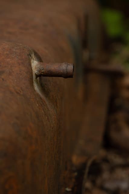 Rusted metal panel with a single bolt