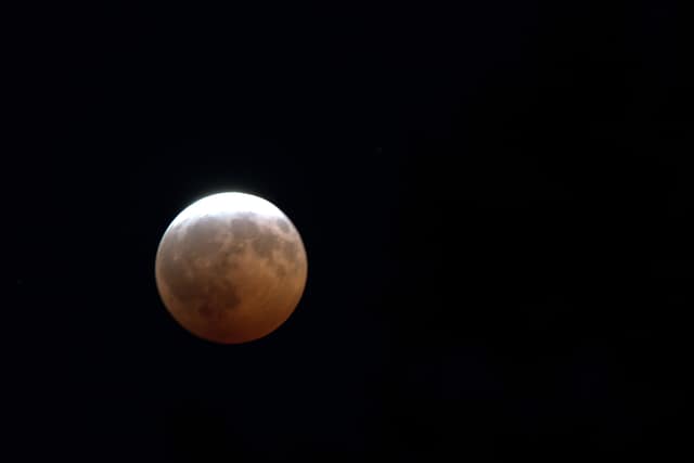 The moon glowing copper red during a lunar eclipse