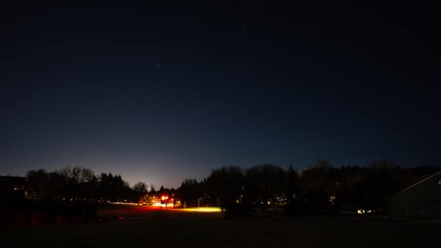 Long-exposure clouds over valley lights