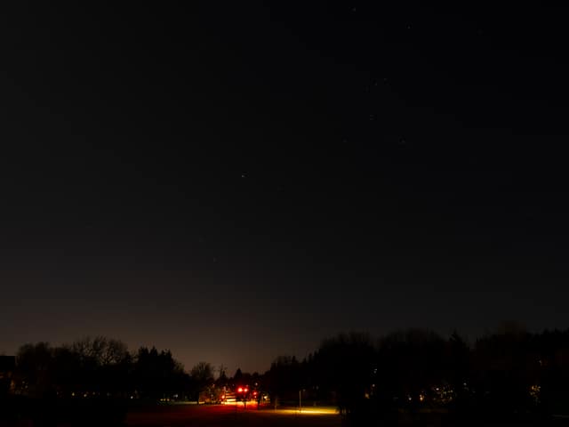 Town glow beneath night clouds
