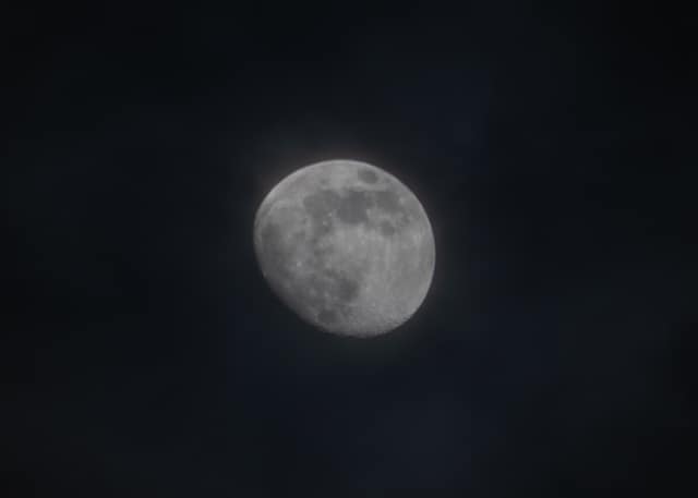A full moon glowing against a black sky